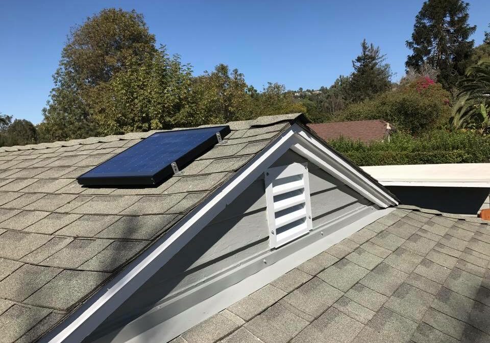 A gable mount solar attic fan installed on a client's roof
